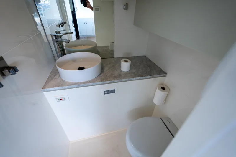 Bikini Bottom Yacht Photos Pics Modern bathroom on 2023 Granocean 57 yacht with sleek sink and toilet.