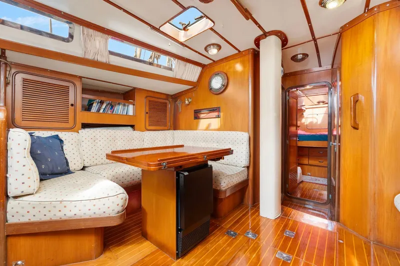 Mandate Yacht Photos Pics Interior of 1996 Tayana 58 yacht with cozy seating and wooden finishes.