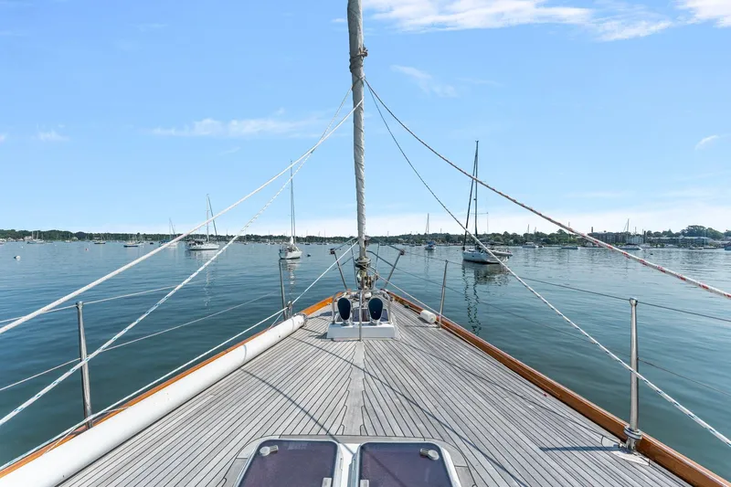 Mandate Yacht Photos Pics Deck view of 1996 Tayana 58 sailboat on calm waters with clear sky.