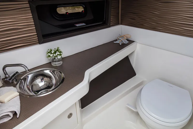  Yacht Photos Pics Manufacturer Provided Image: Modern bathroom in 2020 Sea Ray SLX 310 boat with sink and toilet.