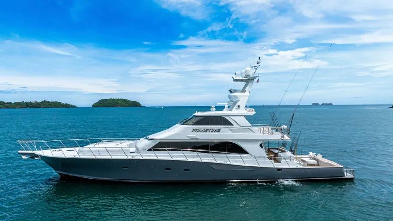 Prime Time Yacht Photos Pics 2002 Queenship 98 Yachtfish cruising on open sea under clear blue sky.