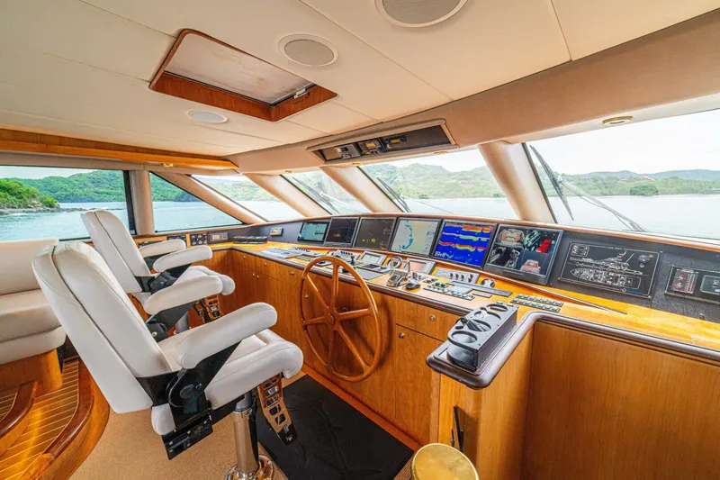 Prime Time Yacht Photos Pics Luxurious 2002 Queenship 98 Yachtfish helm with modern navigation systems and plush seating.