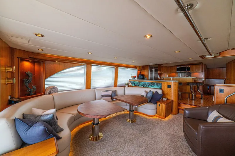 Prime Time Yacht Photos Pics Luxurious interior of 2002 Queenship 98 Yachtfish, featuring elegant seating and modern amenities.