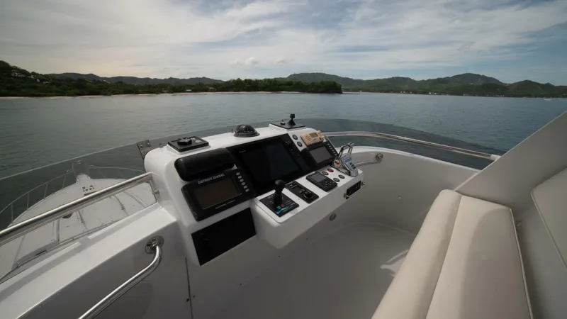 Prime Time Yacht Photos Pics Control panel of 2002 Queenship 98 Yachtfish overlooking serene waters and distant hills.