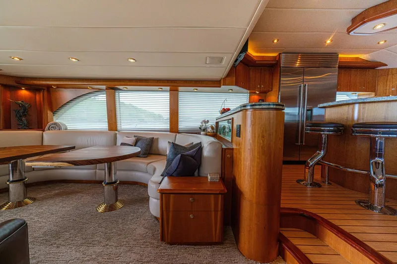 Prime Time Yacht Photos Pics Luxurious interior of 2002 Queenship 98 Yachtfish with elegant seating and modern kitchen area.