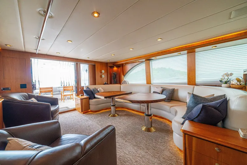 Prime Time Yacht Photos Pics Luxurious interior of 2002 Queenship 98 Yachtfish with elegant seating and wooden accents.