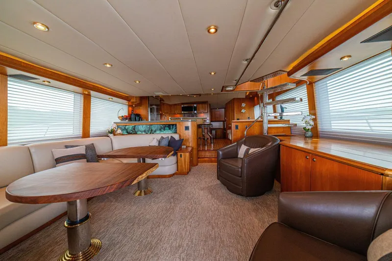 Prime Time Yacht Photos Pics Luxurious interior of 2002 Queenship 98 Yachtfish, featuring elegant seating and wooden accents.