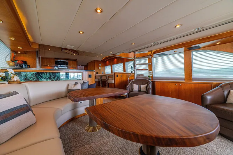 Prime Time Yacht Photos Pics Luxurious interior of 2002 Queenship 98 Yachtfish with elegant wood finishes and plush seating.