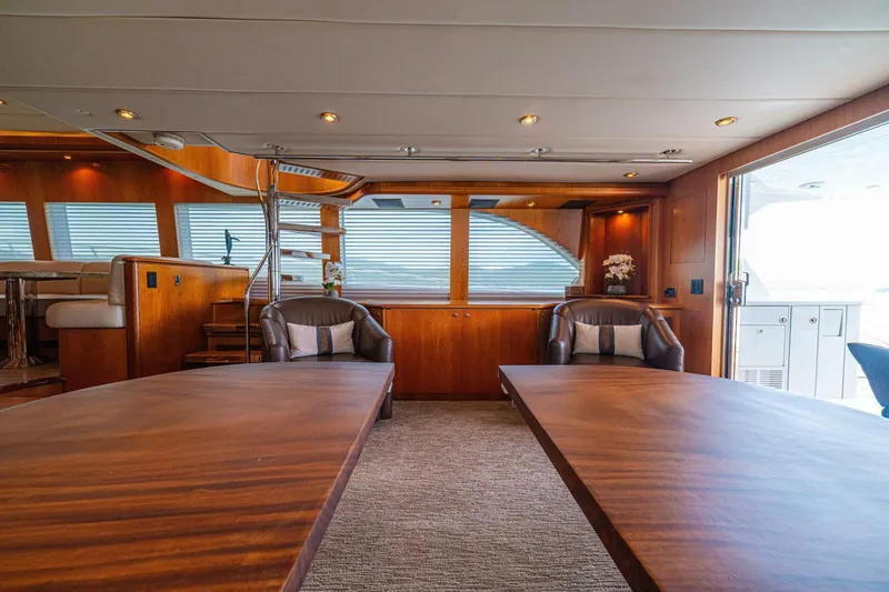 Prime Time Yacht Photos Pics Luxurious interior of 2002 Queenship 98 Yachtfish, featuring elegant wood finishes and comfortable seating.