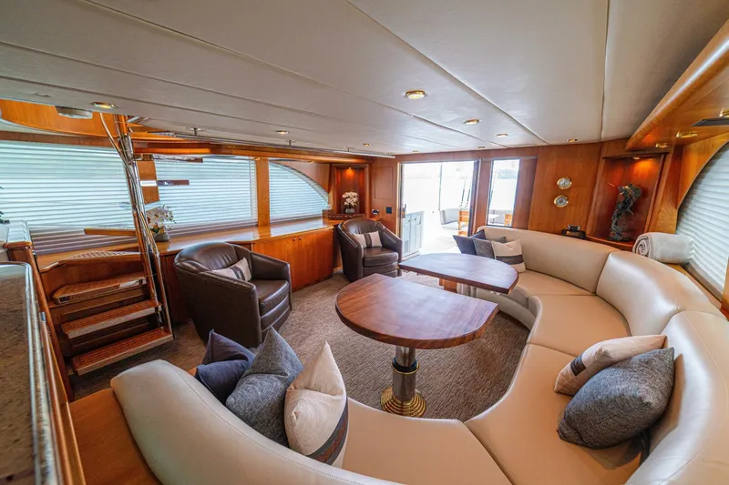 Prime Time Yacht Photos Pics Luxurious 2002 Queenship 98 Yachtfish interior with elegant seating and wooden accents.