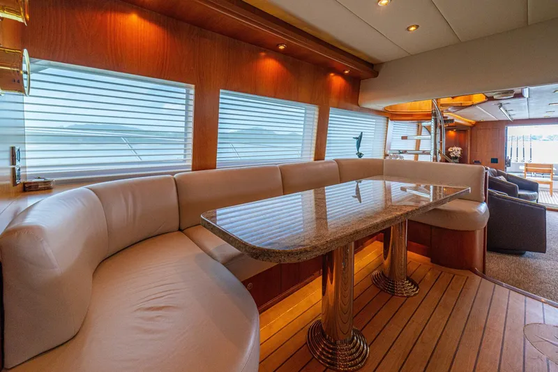 Prime Time Yacht Photos Pics Luxurious interior of 2002 Queenship 98 Yachtfish with elegant dining area and plush seating.