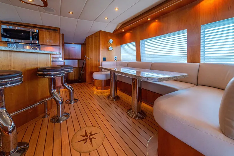 Prime Time Yacht Photos Pics Luxurious 2002 Queenship 98 Yachtfish interior with elegant wood finishes and modern seating.