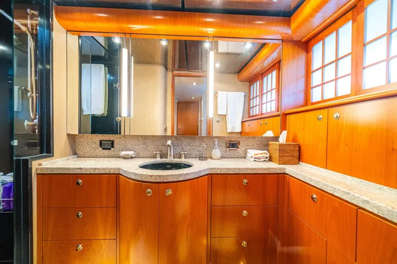 Prime Time Yacht Photos Pics Luxurious bathroom on 2002 Queenship 98 Yachtfish with wood cabinetry and granite countertop.