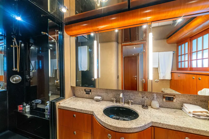 Prime Time Yacht Photos Pics Luxurious bathroom on 2002 Queenship 98 Yachtfish, featuring elegant wood and granite finishes.