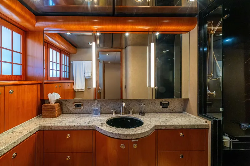 Prime Time Yacht Photos Pics Luxurious bathroom on 2002 Queenship 98 Yachtfish, featuring elegant wood cabinetry and modern fixtures.