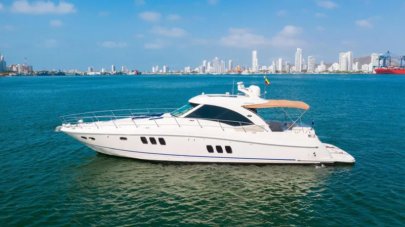  Yacht Photos Pics 2008 Sea Ray 60 Sundancer yacht cruising in a vibrant coastal cityscape.