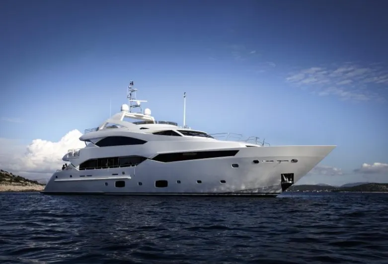  Yacht Photos Pics Luxurious 2014 Sunseeker 131 yacht cruising on open water under a clear blue sky.
