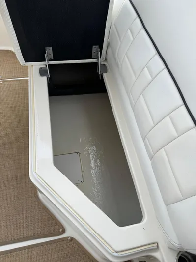 Sea Of O Yacht Photos Pics Open storage compartment on a 2015 Sea Ray 350 SLX boat with white cushioned seating.