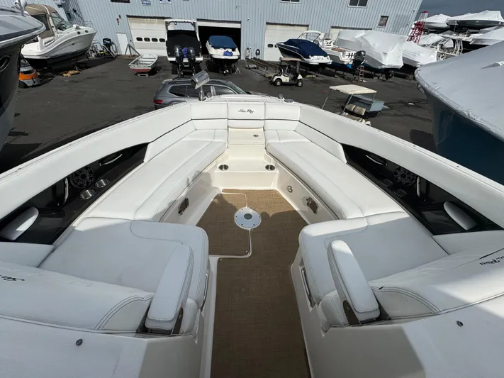 Sea Of O Yacht Photos Pics 2015 Sea Ray 350 SLX boat with spacious white seating in a marina setting.
