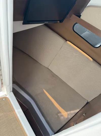 Sea Of O Yacht Photos Pics Interior cabin of 2015 Sea Ray 350 SLX with beige seating and a mounted TV.