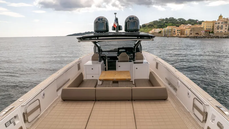  Yacht Photos Pics 2024 Pardo Yachts 50 luxury yacht with spacious deck and seating, cruising near coastal town.