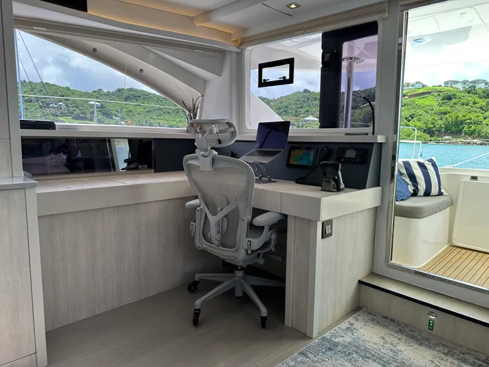  Yacht Photos Pics Interior of Leopard 58 yacht with desk and chair, ocean view.