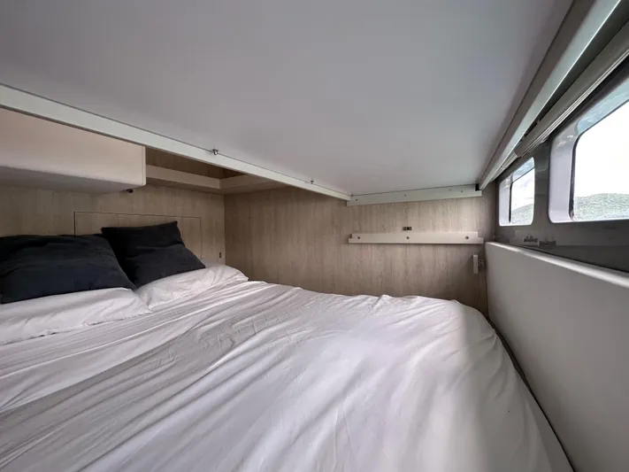  Yacht Photos Pics Interior of a Leopard 58 yacht, bedroom with bed and windows.