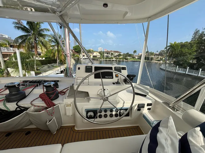  Yacht Photos Pics Leopard 58 yacht cockpit with steering wheel, 2019 model, overlooking water and palm trees.