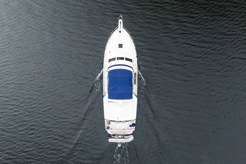 Blue Fish Yacht Photos Pics Overhead view of 1988 Tollycraft 44CPMY yacht cruising on water.
