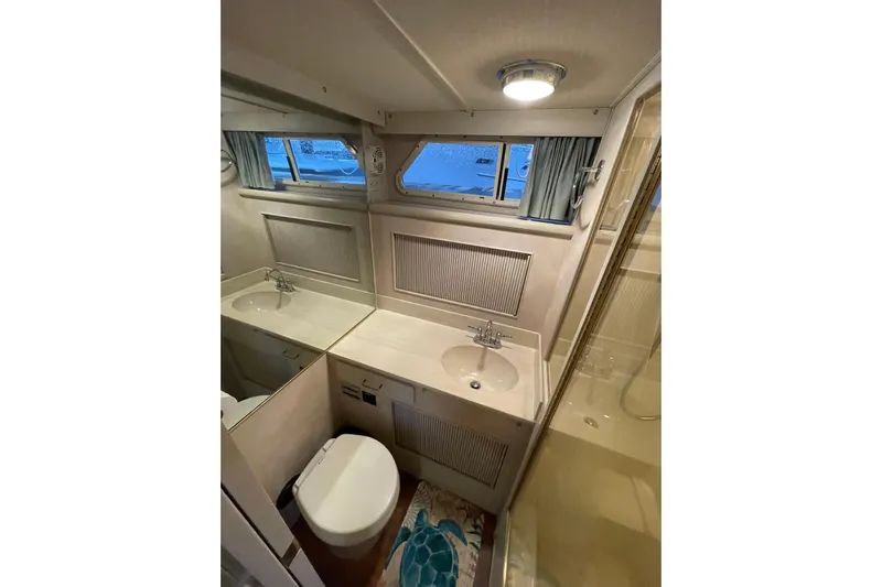Blue Fish Yacht Photos Pics 1988 Tollycraft 44CPMY yacht bathroom with sink, toilet, and shower.