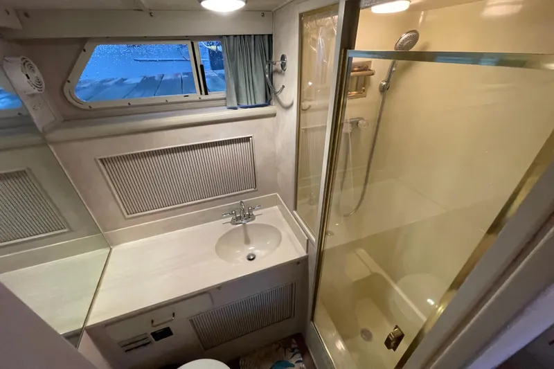 Blue Fish Yacht Photos Pics 1988 Tollycraft 44CPMY yacht bathroom with sink, shower, and window.