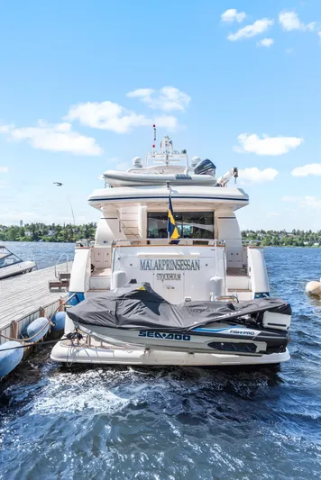  Yacht Photos Pics Luxury yacht Horizon Elegance 80, 2000 model, docked with jet ski, clear sky background.