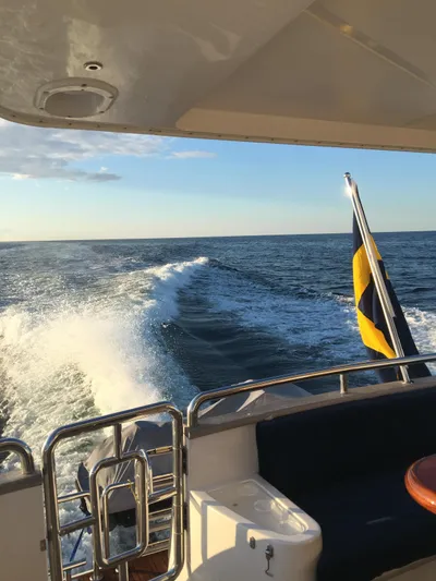  Yacht Photos Pics A Horizon Elegance 80 yacht cruising on open sea, leaving a wake behind.