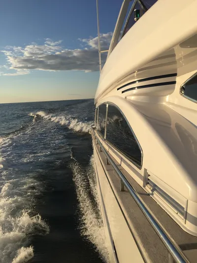  Yacht Photos Pics Luxury yacht Horizon Elegance 80 cruising on open sea at sunset, 2000 model.