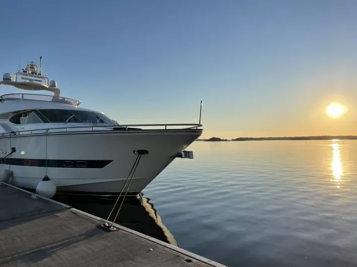  Yacht Photos Pics Luxury yacht Horizon Elegance 80 docked at sunset, calm waters reflecting the sun.