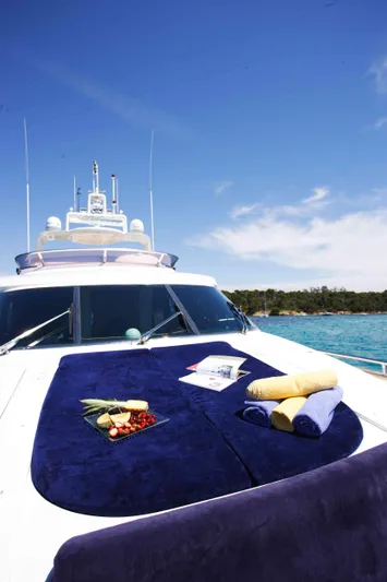  Yacht Photos Pics Luxurious Horizon Elegance 80 yacht deck with towels, fruit, and magazine under clear blue sky.