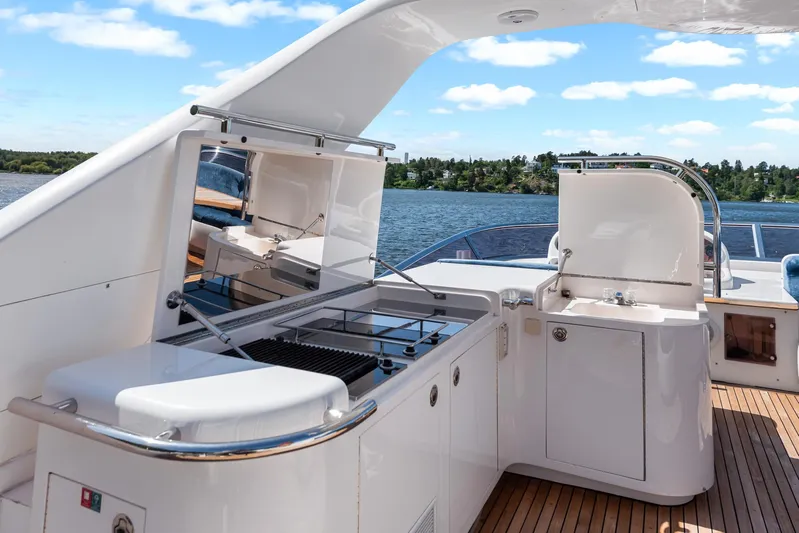  Yacht Photos Pics Luxury yacht deck with outdoor kitchen, Horizon Elegance 80, 2000 model, on a sunny day.