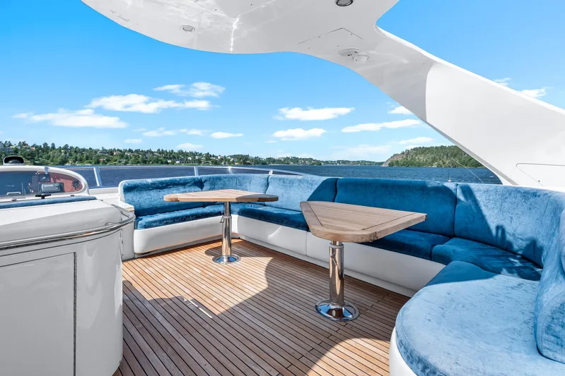  Yacht Photos Pics Luxurious Horizon Elegance 80 yacht deck with blue seating and wooden tables, 2000 model.