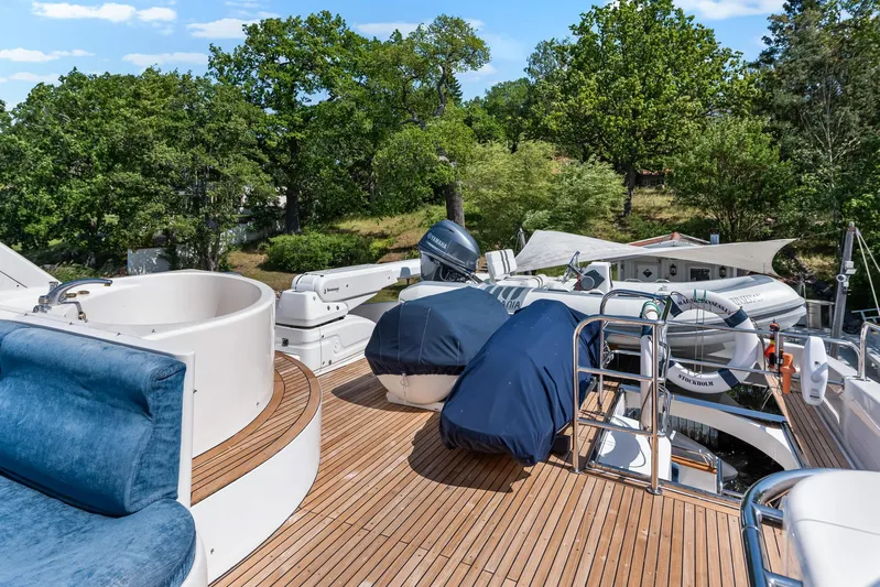  Yacht Photos Pics Luxurious Horizon Elegance 80 yacht deck with jacuzzi and seating, surrounded by lush greenery.