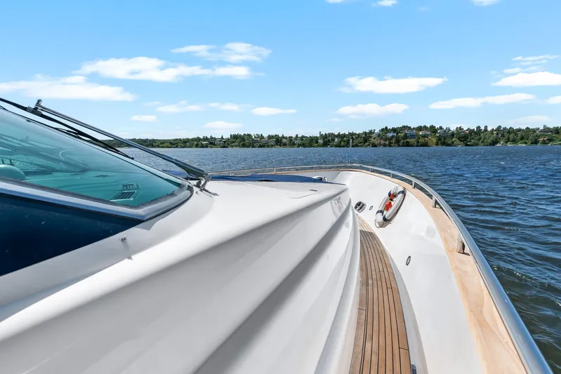  Yacht Photos Pics Luxury yacht Horizon Elegance 80 cruising on a serene lake, clear blue sky above.