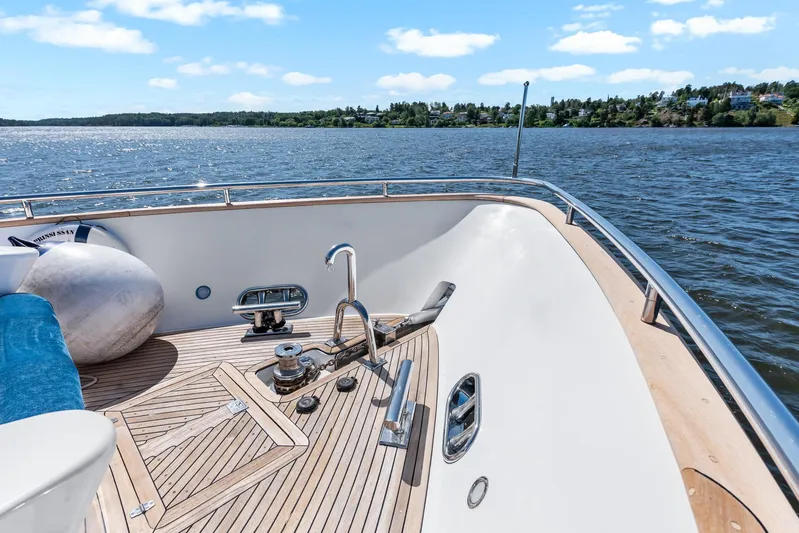  Yacht Photos Pics Luxury yacht deck of 2000 Horizon Elegance 80, overlooking serene waters and distant shoreline.