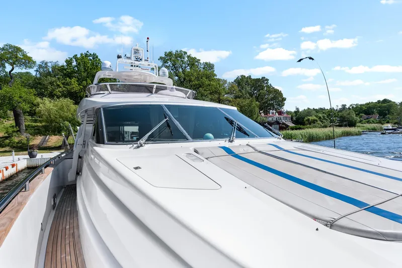  Yacht Photos Pics Luxury yacht Horizon Elegance 80, 2000 model, docked by a scenic waterfront.