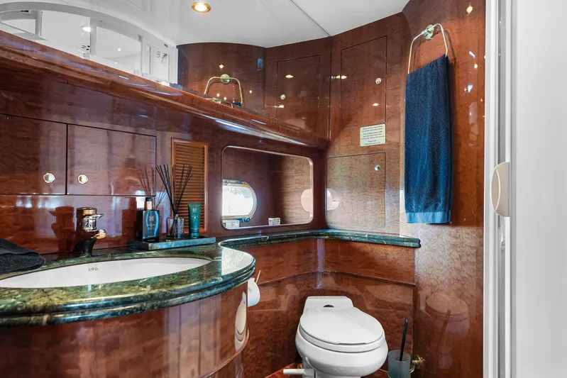  Yacht Photos Pics Luxurious yacht bathroom with wood paneling, marble countertop, and modern fixtures on Horizon Elegance 80.