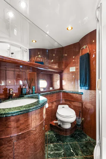  Yacht Photos Pics Luxurious yacht bathroom with marble accents, elegant wood paneling, and modern fixtures on Horizon Elegance 80.