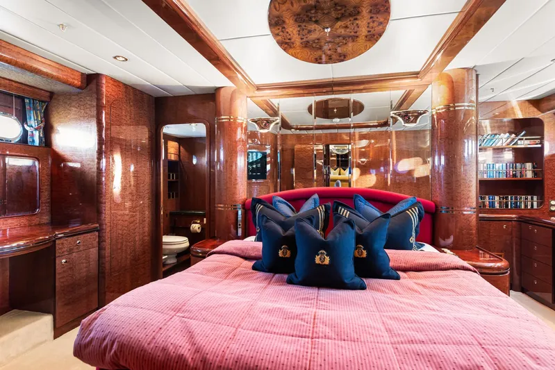 Yacht Photos Pics Luxurious yacht bedroom with elegant wood finish, plush bedding, and decorative pillows. Horizon Elegance 80, 2000.