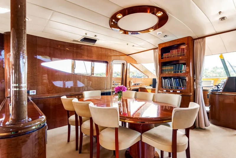  Yacht Photos Pics Luxurious interior of 2000 Horizon Elegance 80 yacht with dining area and bookshelf.
