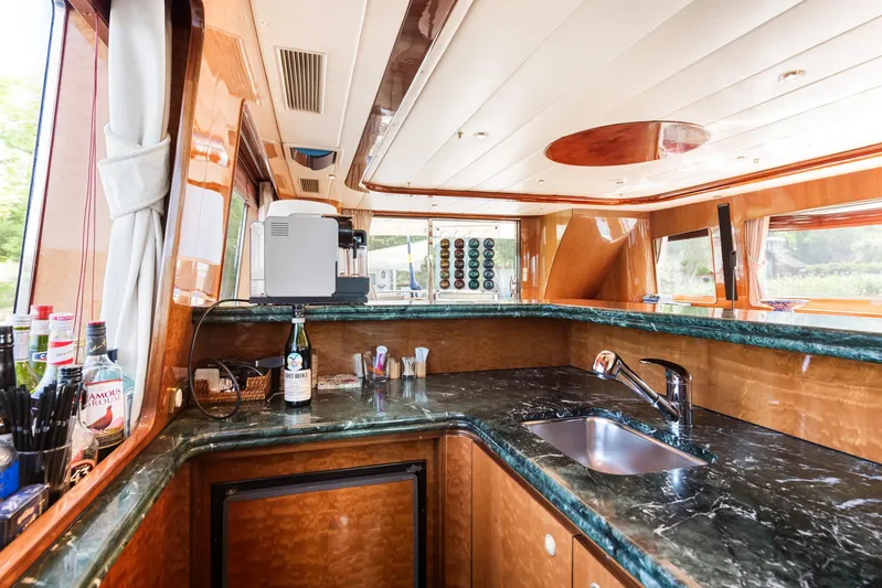  Yacht Photos Pics Luxurious yacht kitchen with marble countertops, wooden cabinetry, and modern appliances on Horizon Elegance 80.