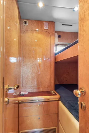  Yacht Photos Pics Luxurious cabin interior of 2000 Horizon Elegance 80 yacht with wooden finish and bunk bed.