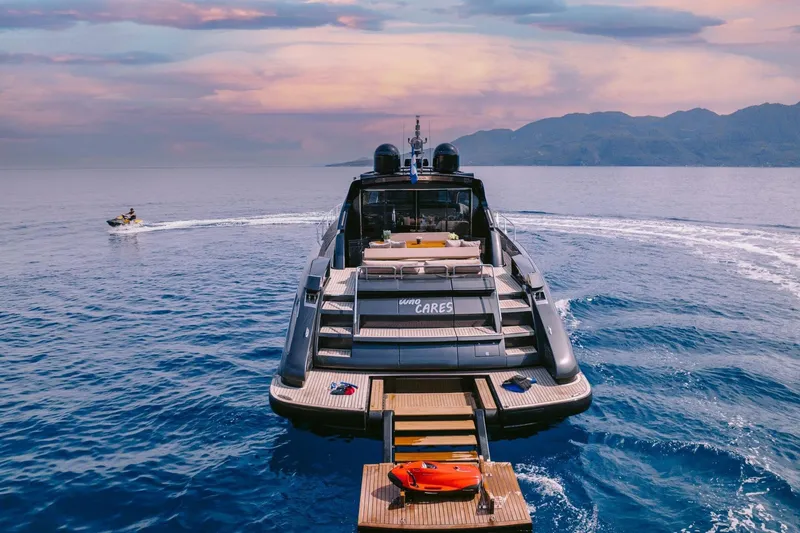 Who Cares Yacht Photos Pics Luxury 2006 Riva 68 Ego yacht on serene ocean with jet ski nearby.