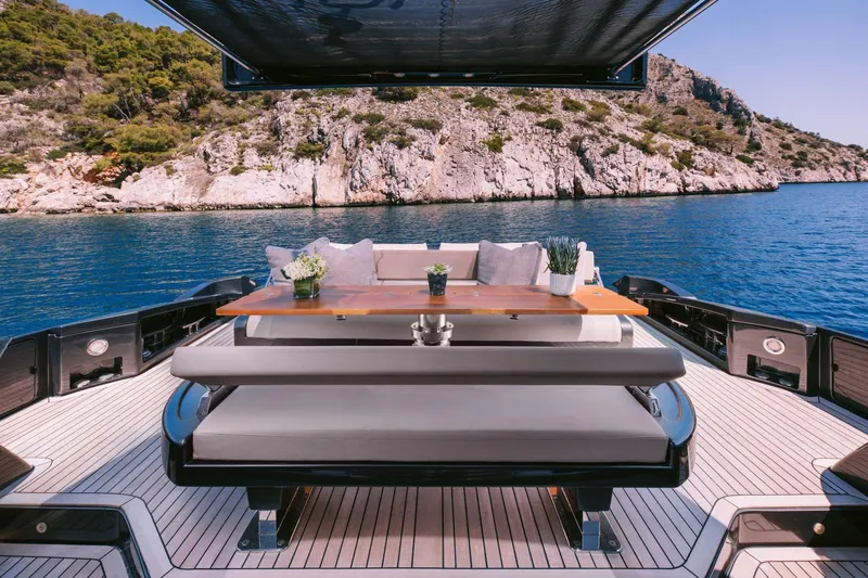 Who Cares Yacht Photos Pics Luxurious 2006 Riva 68 Ego yacht deck with elegant seating and scenic ocean view.